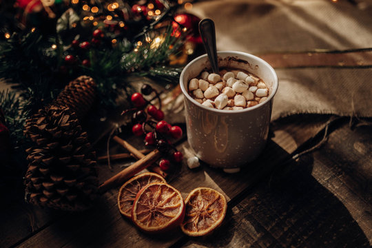 Christmas decorations near hot chocolate and spices