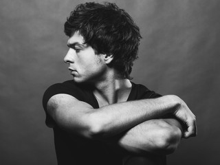 Portrait of Handsome Young Man. A Men Posing on a Gray Background. Black And White Photo