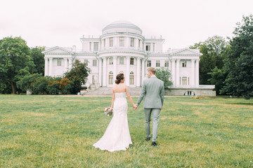Stylish wedding in St. Petersburg. Elagin island and castle in the background. Walking photo...