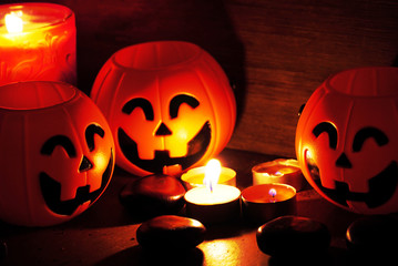 Three pumpkins smile and candle decorate for halloween night