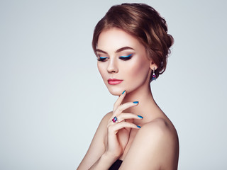 Portrait Beautiful Woman with Jewelry. Model Girl with Blue Manicure on Nails. Elegant Hairstyle. Blue Make-up Arrows. Beauty and Accessories