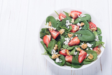 Strawberry salad with spinach , cheese and walnut