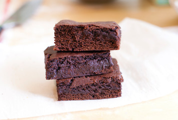 Close up image of fudge brownie slices stacked on top of each other