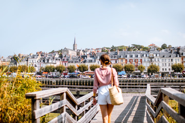 Woman enjoying great view on the beautiful riverside in Trouville city, famous french resort in Normandy © rh2010