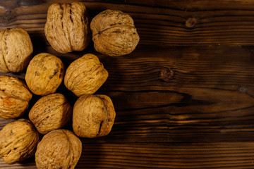 Walnuts on wooden table. Top view, copy space