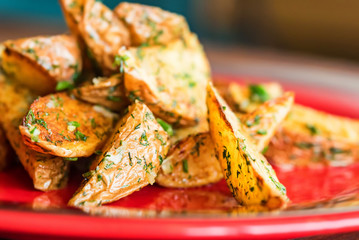 Baked potato wedges with dill and spices close