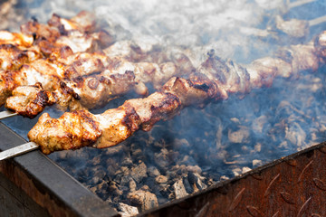 Cooking barbecue dish named shashlyk on skewers close