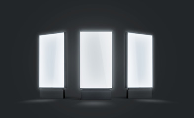 Blank white glowing pylon mock up set, isolated in darkness, 3d rendering. Empty illuminated screen mock up, different sides. Clear luminous poster for ad or affiche. Outdoor lightbox template.