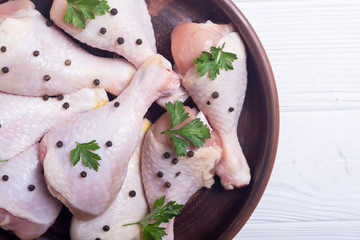 Raw chicken legs with spices and parsley