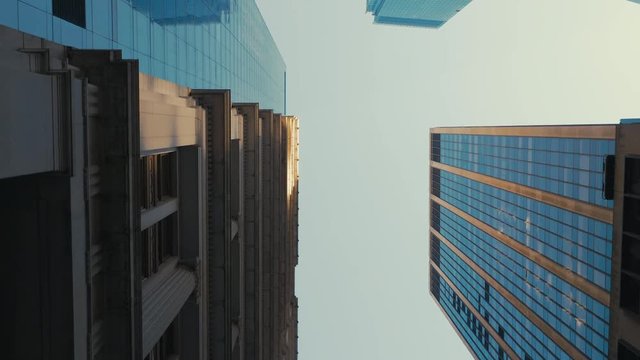 TRACKING GIMBAL Walking camera straight up through modern skyscraper buildings in downtown New York, USA. 4K UHD