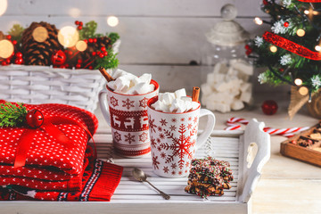 Two mugs with hot drink and marshmallows on the top. Christmas colorful still life. Cozy festive mood.