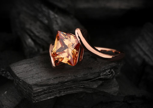 Jewelry Ring With Big Topaz Gem On Black Coal Background