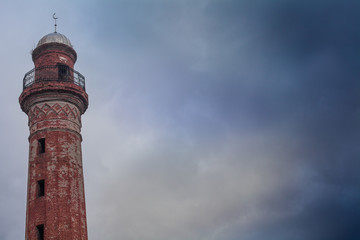 Old minaret against the sky