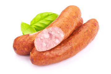 Hungarian Smoked Sausages with basil leaves, isolated on a white background. Close-up.