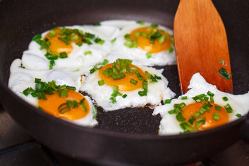 Fried eggs in a frying pan with a bow.