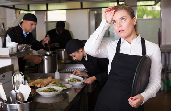 Disappointed waitress in restaurant kitchen