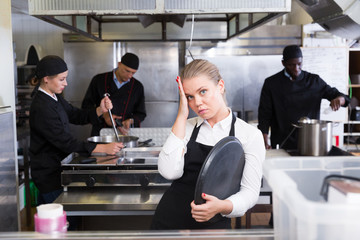 Upset waitress in kitchen of restaurant
