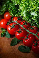 Branch tomatoes cherry on a wooden table