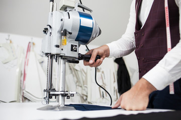 Young bearded tailor working on new cloting design