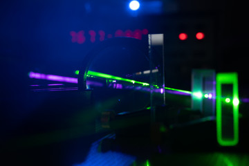 green and blue laser on optical table in physics laboratory