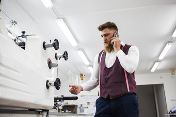 Young bearded tailor working on new cloting design