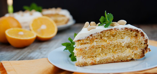 Orange and carrotn cake, wooden background. Rustic style. Banner.