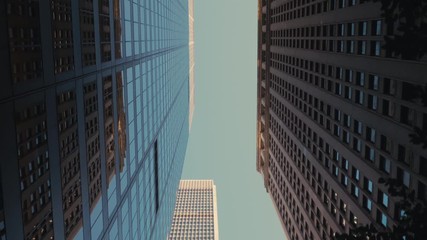 TRACKING GIMBAL Walking camera straight up through modern skyscraper buildings in downtown New York, USA. 4K UHD - Powered by Adobe