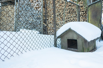 Empty doghouse in winter in the country side