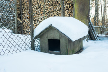 Empty doghouse in winter in the country side