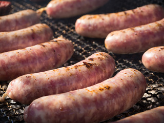 Homemade meat sausages are fried on smoke.
