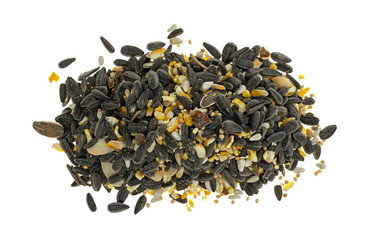 Top view of a pile of wild bird food with assorted seeds and peanuts isolated on a white background.