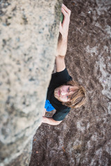 Portrait of a young man climbing on a hill