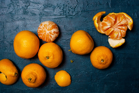 Fresh Ripe Mandarins On The Textured Navy Blue Table