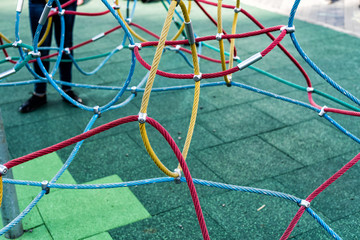 Multicolored steel rope on the playground
