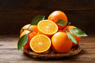 Muurstickers fresh orange fruits on wooden table © Nitr
