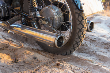 Motorcycle wheel on a sandy road, close-up