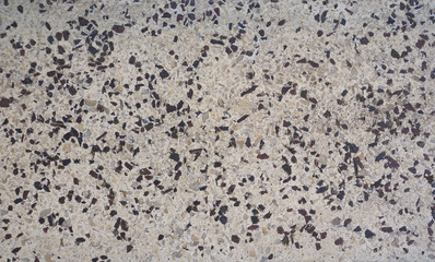 The texture of gray artificial stone interspersed with granite chips.