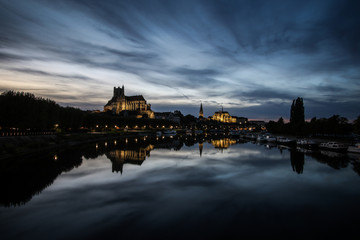 Auxerre, French city with cathedral and river at night