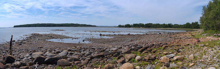 Wide view of Sears Island, the causeway and peninsula and coastline at Searsport Maine in the summertime.