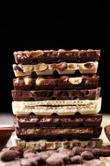 Chocolate bars on table with chocolate tower.