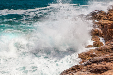 Rocks, waves and surf on the coastline shores and beach
