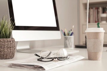 newspaper and coffee over office desk
