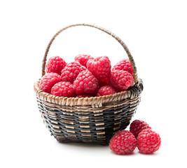 Fototapeta na wymiar Fresh raspberries in a small wicker basket