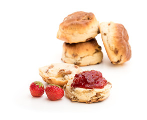 Traditional scones with fresh strawberries and jam isolated on white