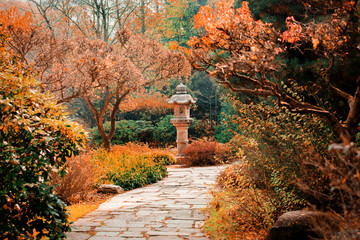 View at monument in japanese garden and alley. Autumn season time scene