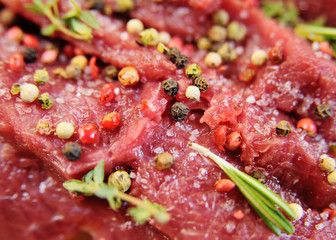 raw beef fillet with pepper and thyme, ready to grill.