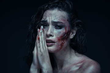 Beautiful girl with a scar on her face in the blood