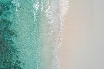 Fototapeta na wymiar Beautiful tropical white empty beach and sea waves seen from above. Seychelles beach aerial view
