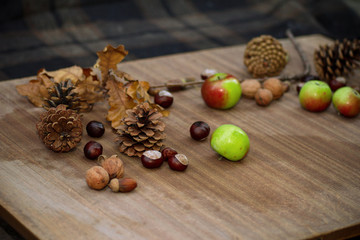 Autumn still life with apples and nuts on a wooden table