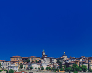 Skyline of Bergamo, Italy under blue sky